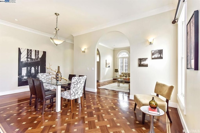 dining area with parquet floors and crown molding