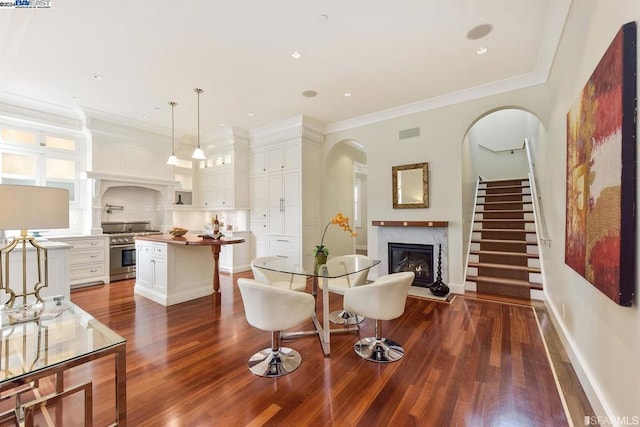 living room with crown molding and dark wood-type flooring