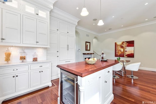 kitchen with wine cooler, tasteful backsplash, pendant lighting, dark hardwood / wood-style floors, and white cabinetry