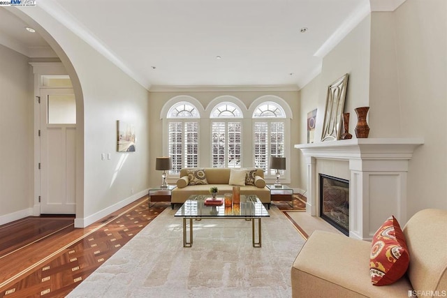 living room featuring ornamental molding and light parquet floors