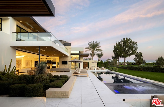 view of pool with outdoor lounge area and a patio area