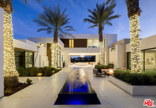 outdoor building at dusk featuring an outdoor fire pit