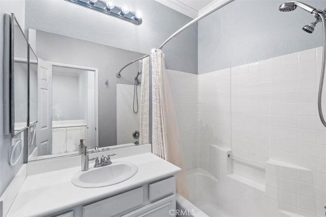 bathroom with vanity, shower / bath combo with shower curtain, and crown molding