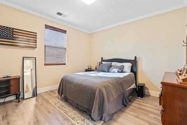 bedroom featuring crown molding and light hardwood / wood-style flooring