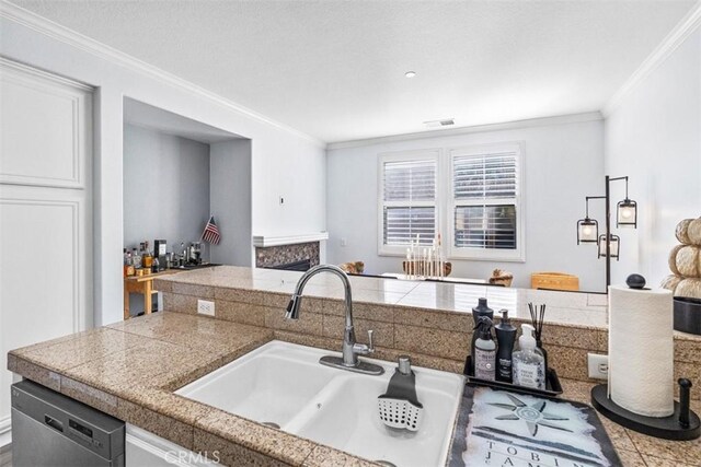 13559 Mashona Ave, Chino, CA 91710 - kitchen with tile counters, dishwasher, crown molding, a fireplace, and a sink