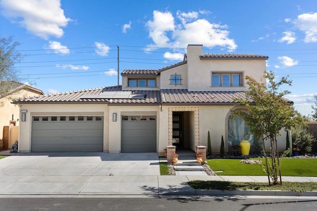 mediterranean / spanish home with a garage