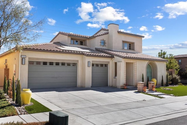 mediterranean / spanish house featuring a garage