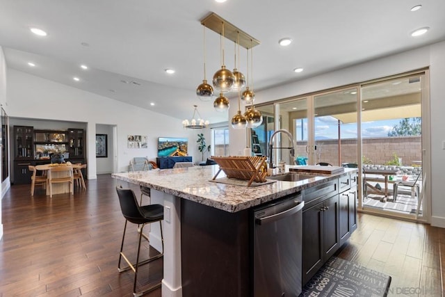 kitchen featuring dishwasher, pendant lighting, a center island with sink, and dark hardwood / wood-style floors