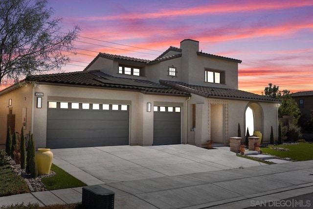 mediterranean / spanish home featuring a garage