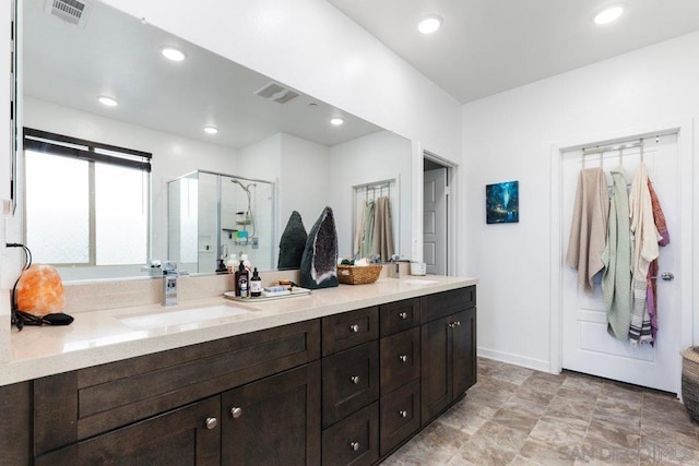 bathroom with vanity and a shower with shower door