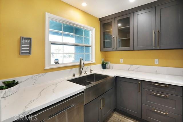 8121 San Mateo Cir, Buena Park, CA 90620 - kitchen with a sink, glass insert cabinets, light stone counters, recessed lighting, and dishwasher