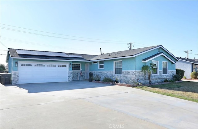 8121 San Mateo Cir, Buena Park, CA 90620 - ranch-style home with stone siding, roof mounted solar panels, stucco siding, and driveway