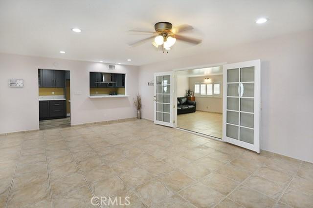 8121 San Mateo Cir, Buena Park, CA 90620 - unfurnished living room featuring ceiling fan, french doors, and light tile patterned floors