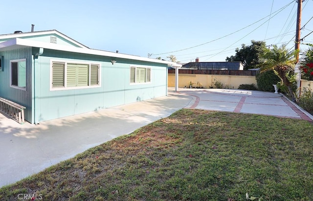 8121 San Mateo Cir, Buena Park, CA 90620 - view of side of property featuring a lawn and a patio area