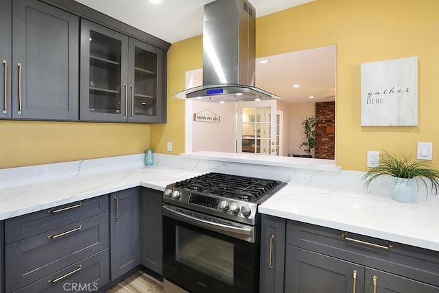 8121 San Mateo Cir, Buena Park, CA 90620 - kitchen with stainless steel gas range oven, island range hood, gray cabinetry, light stone counters, and recessed lighting