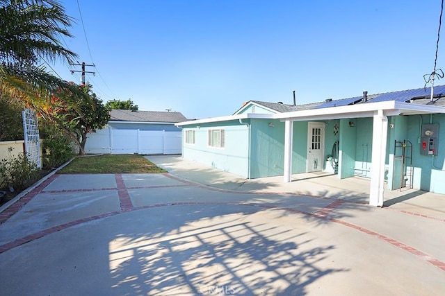 8121 San Mateo Cir, Buena Park, CA 90620 - rear view of house featuring solar panels and a patio