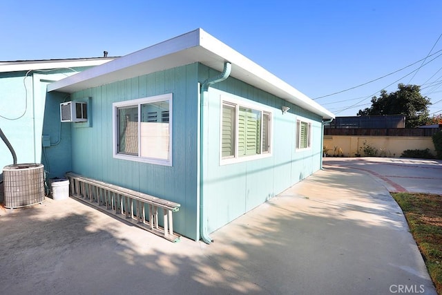 8121 San Mateo Cir, Buena Park, CA 90620 - view of side of home with central air condition unit and a wall mounted air conditioner
