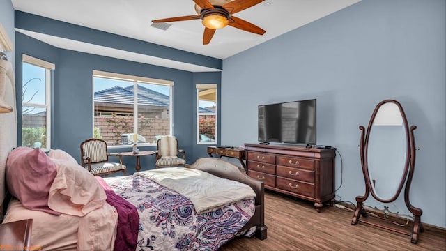 bedroom with ceiling fan and hardwood / wood-style flooring