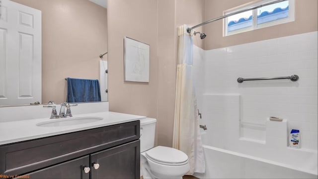 full bathroom with vanity, shower / tub combo, and toilet