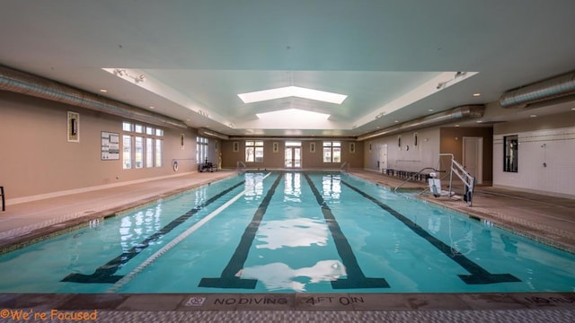 view of swimming pool with a skylight