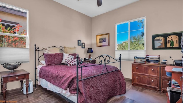 bedroom with ceiling fan and dark hardwood / wood-style flooring