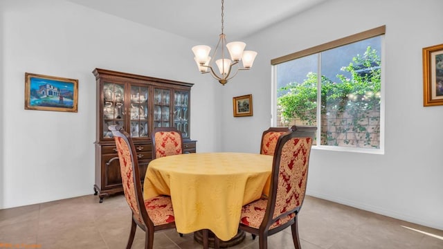 tiled dining area featuring a chandelier