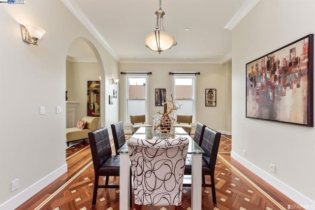 dining space featuring crown molding and parquet flooring