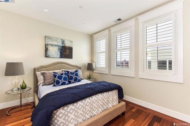 bedroom with dark hardwood / wood-style floors