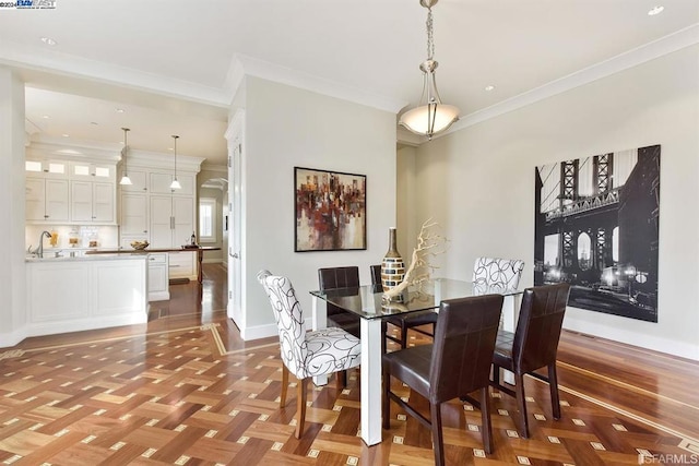 dining space featuring sink, light parquet flooring, and ornamental molding