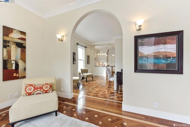 living area with crown molding and parquet floors