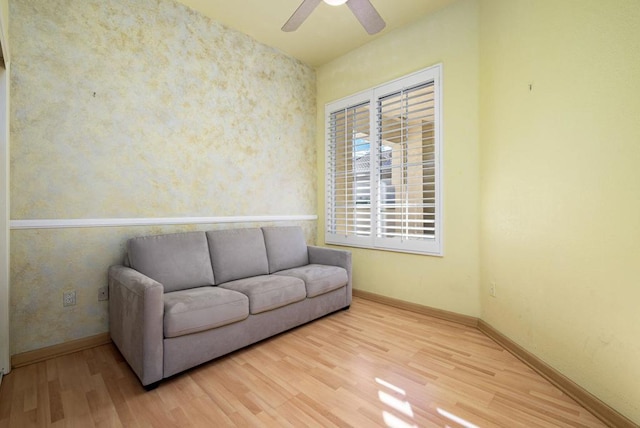 sitting room with ceiling fan and light hardwood / wood-style flooring