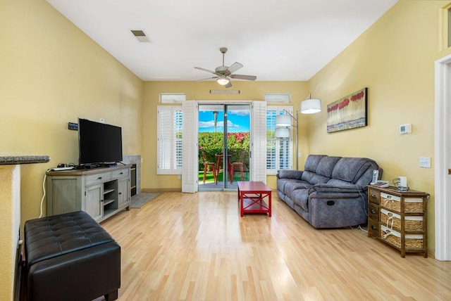 living room with ceiling fan and wood-type flooring