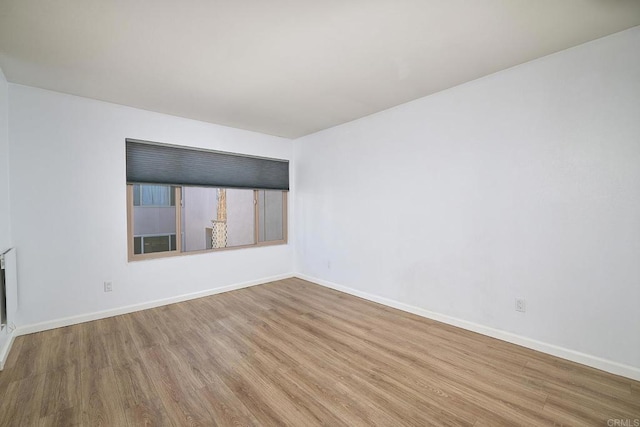 empty room with hardwood / wood-style floors