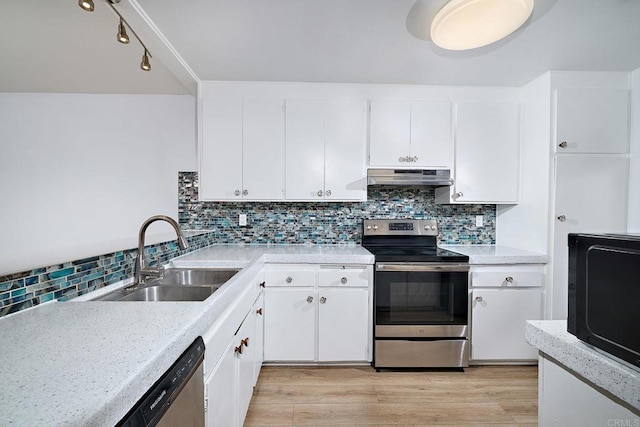 kitchen with appliances with stainless steel finishes, tasteful backsplash, sink, light hardwood / wood-style flooring, and white cabinetry