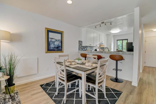 dining area featuring light wood-type flooring