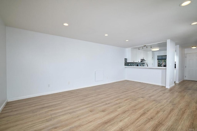 unfurnished living room featuring light hardwood / wood-style floors