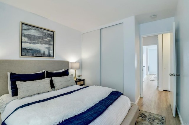 bedroom featuring light hardwood / wood-style floors and a closet