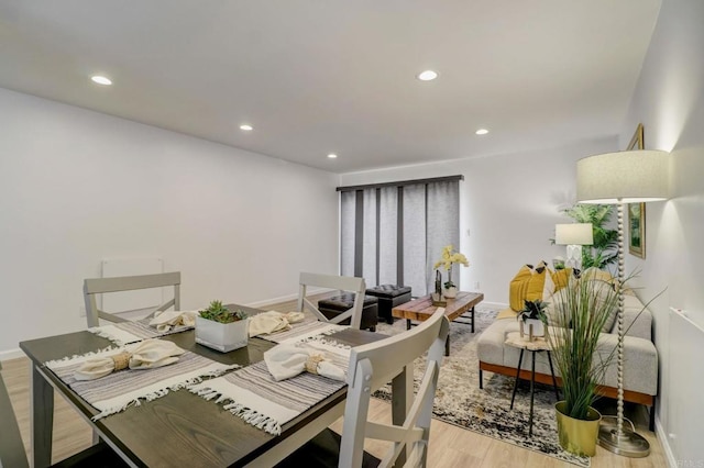 dining space with hardwood / wood-style floors