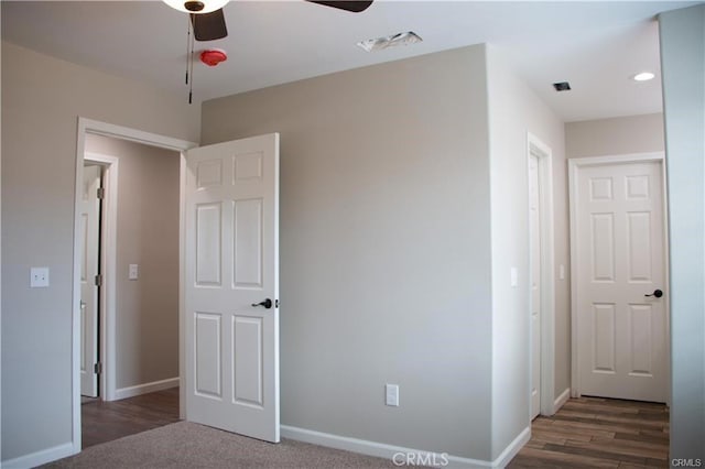 unfurnished bedroom with ceiling fan and dark hardwood / wood-style floors