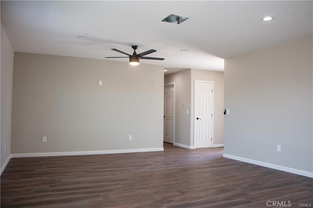 spare room featuring dark hardwood / wood-style floors and ceiling fan