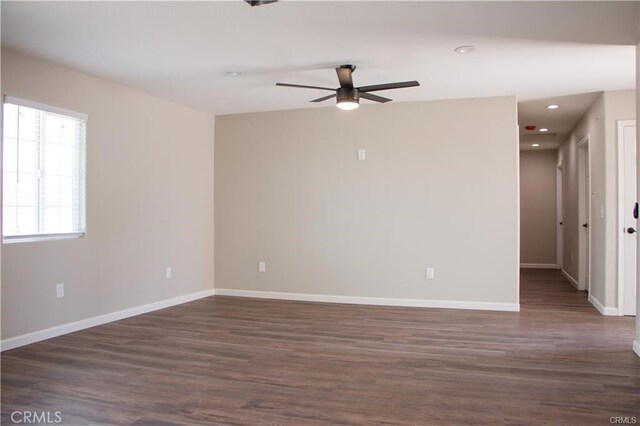 unfurnished room featuring ceiling fan and dark wood-type flooring