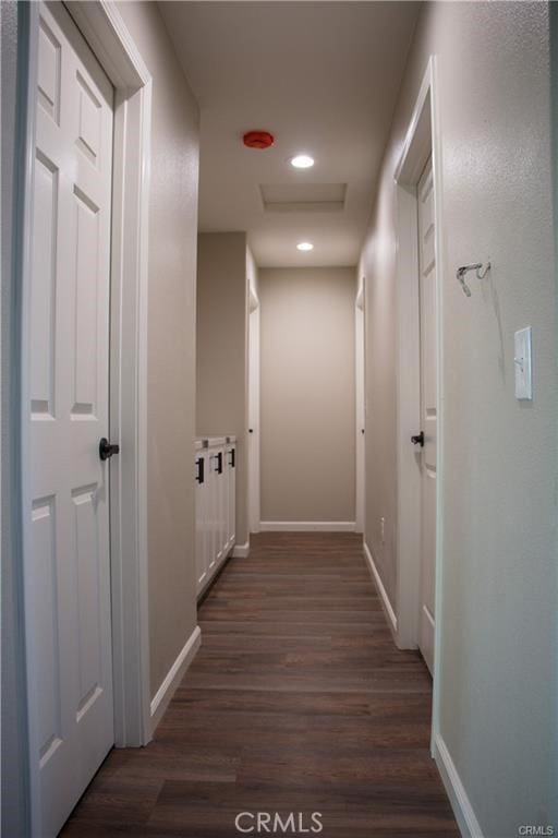 hallway with dark hardwood / wood-style flooring