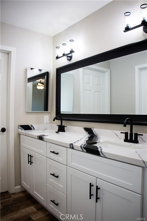 bathroom with vanity and hardwood / wood-style flooring