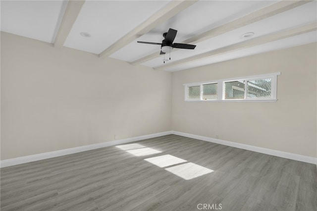 unfurnished room featuring beam ceiling, ceiling fan, and light hardwood / wood-style floors