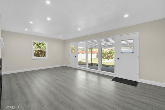 unfurnished living room with hardwood / wood-style floors and a healthy amount of sunlight