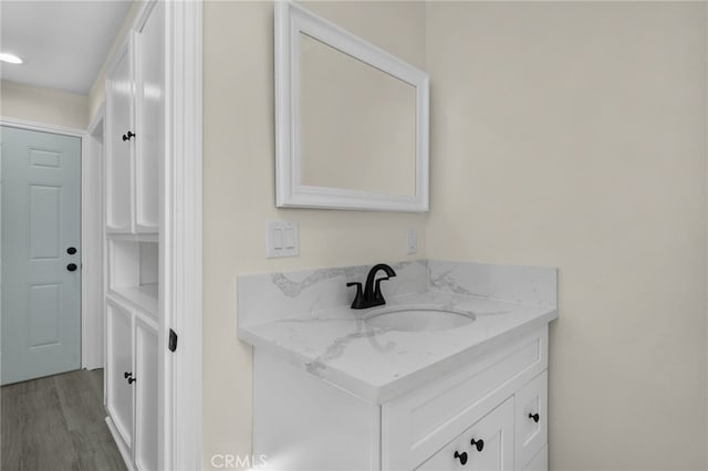 bathroom with hardwood / wood-style floors and vanity