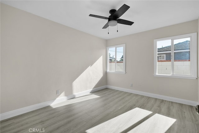 empty room featuring ceiling fan and light hardwood / wood-style flooring