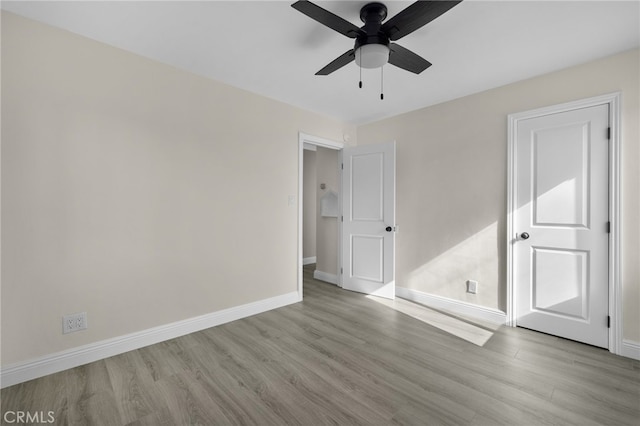 empty room with light hardwood / wood-style flooring and ceiling fan