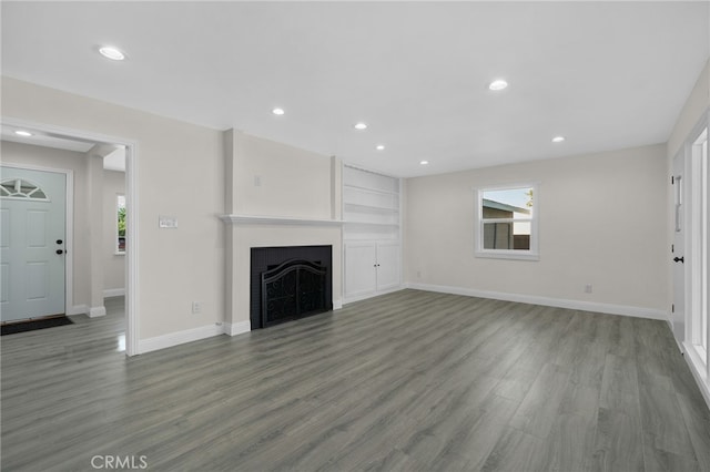 unfurnished living room featuring dark hardwood / wood-style floors