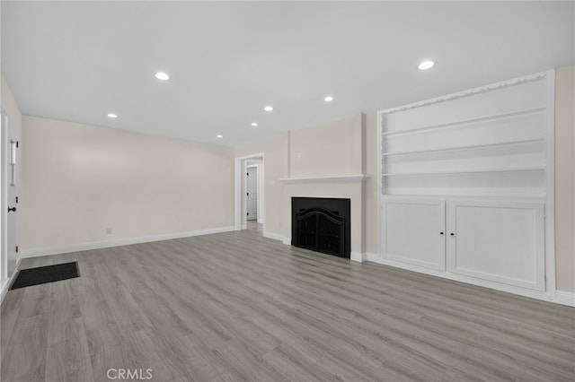 unfurnished living room featuring light wood-type flooring